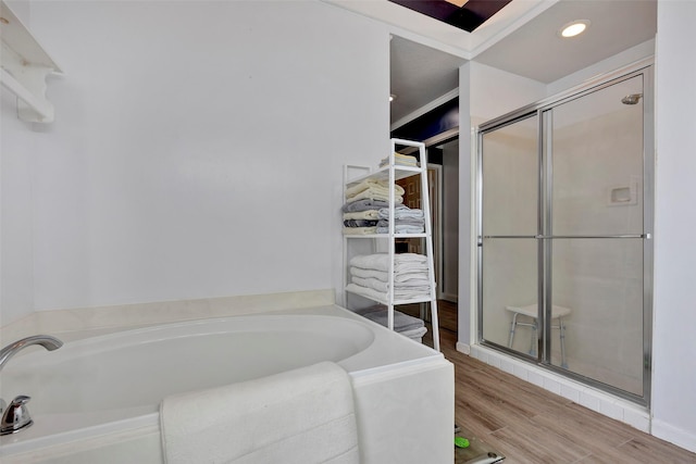 bathroom featuring independent shower and bath and hardwood / wood-style flooring