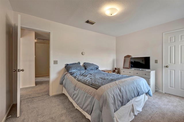 carpeted bedroom featuring a textured ceiling