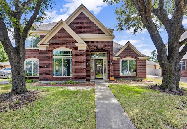 view of front of house featuring a garage and a front lawn