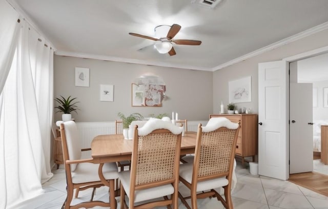 dining room with ceiling fan and ornamental molding