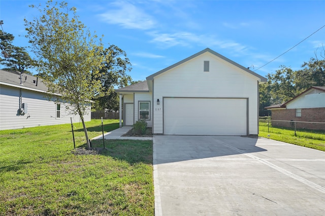 view of front of property with a front yard, an attached garage, fence, and driveway