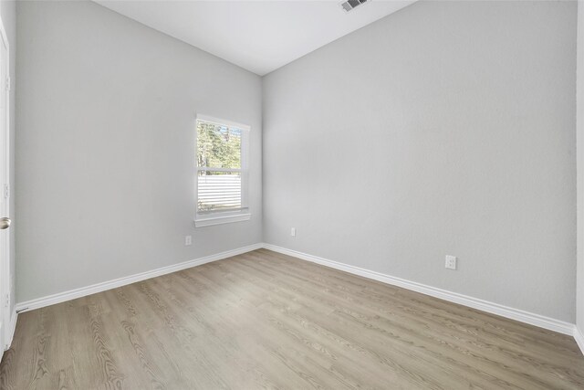 unfurnished room with light hardwood / wood-style floors