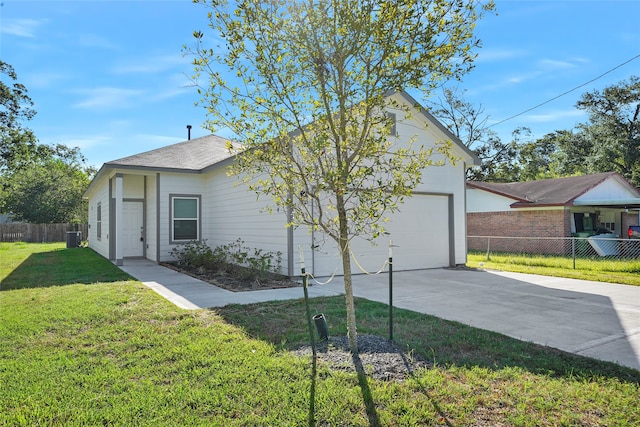 view of property exterior with a garage, a lawn, and central AC