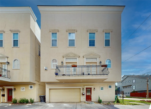 townhome / multi-family property featuring a balcony and a garage