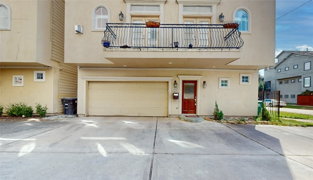 view of front of property featuring a balcony and a garage