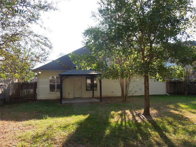 back of property featuring a gazebo, a yard, and a patio area