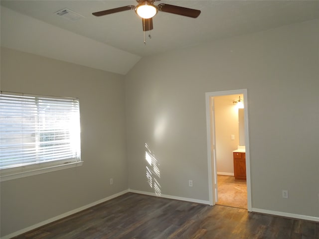 spare room featuring vaulted ceiling, ceiling fan, and dark hardwood / wood-style flooring