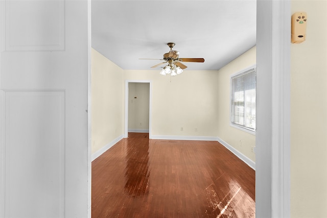 empty room with ceiling fan and hardwood / wood-style floors