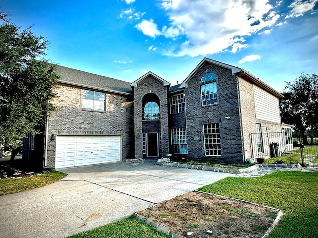 view of property featuring a front lawn and a garage