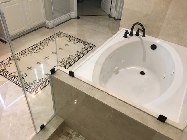 bathroom featuring tiled bath