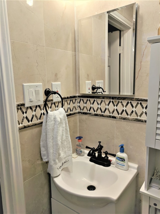 bathroom with vanity and tile walls