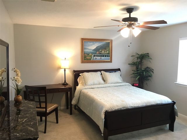 bedroom with ceiling fan and light carpet