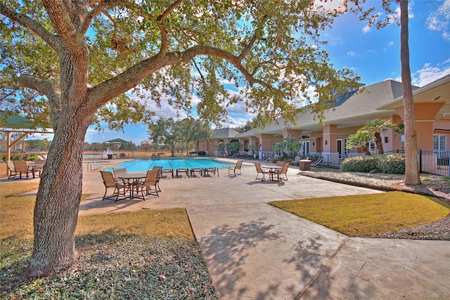 view of swimming pool featuring a patio area and a lawn