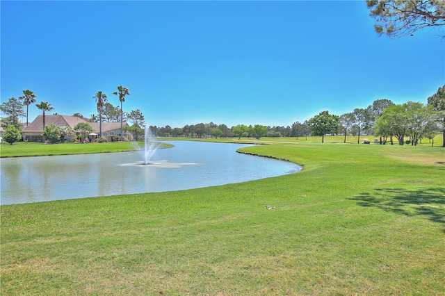 view of home's community with a yard and a water view