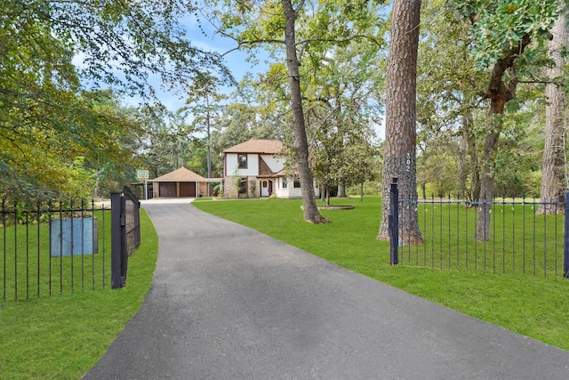 view of front of home with a front lawn and a garage