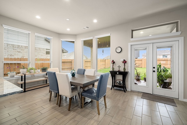 dining room featuring french doors and light hardwood / wood-style flooring