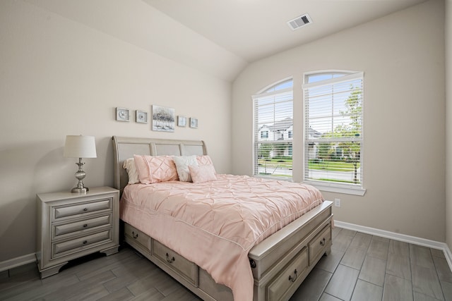 bedroom featuring lofted ceiling and hardwood / wood-style floors