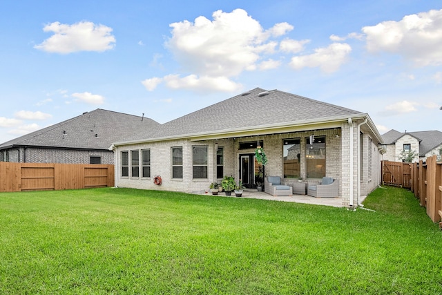 rear view of house with an outdoor hangout area, a lawn, and a patio