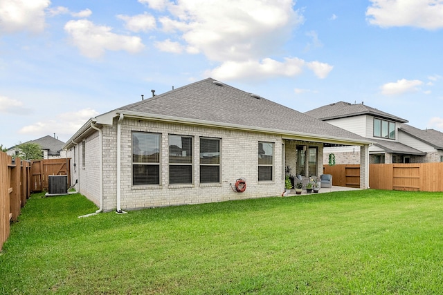 back of house featuring cooling unit, a yard, and a patio area