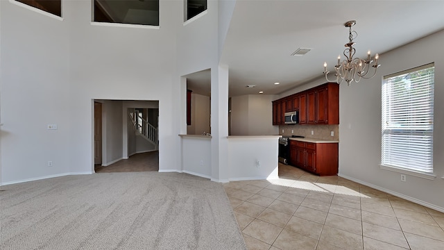 unfurnished living room with light tile patterned flooring and a chandelier