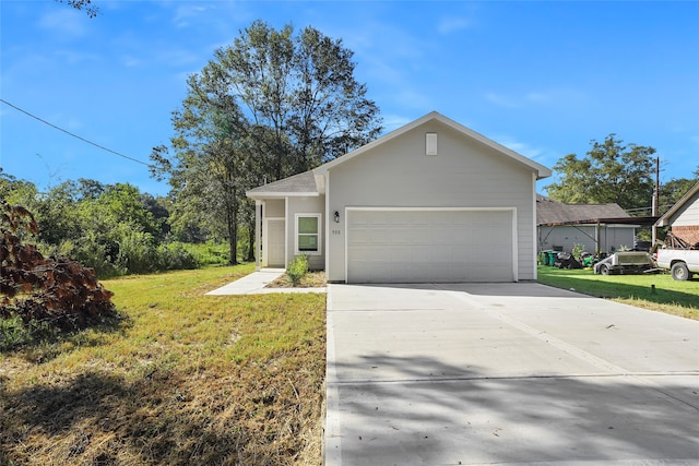 view of front of home featuring a garage and a front yard