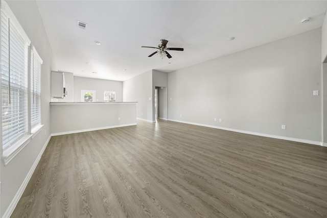 unfurnished living room with hardwood / wood-style floors and ceiling fan