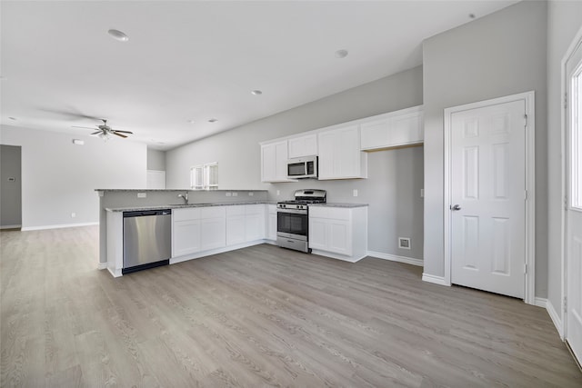 kitchen with light wood-type flooring, white cabinetry, sink, and stainless steel appliances