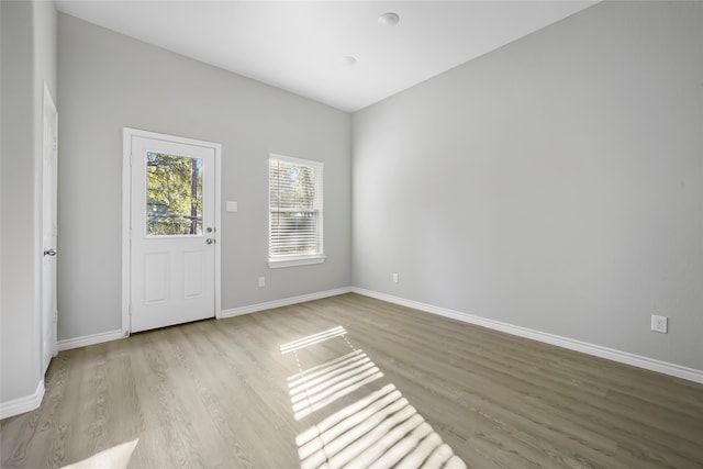 empty room with light hardwood / wood-style flooring