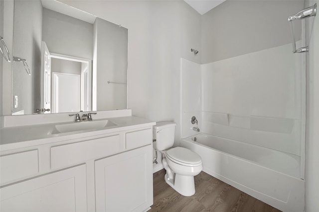 full bathroom with shower / bathing tub combination, vanity, hardwood / wood-style floors, and toilet