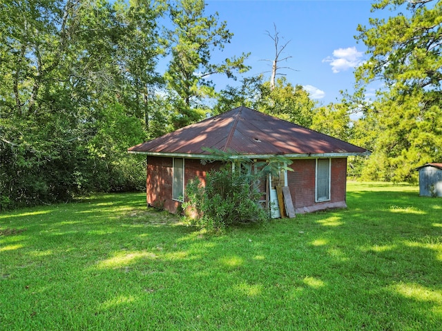 view of outbuilding with a yard