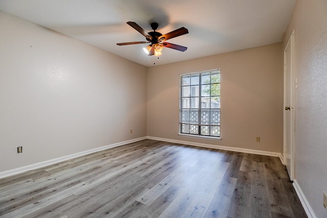 empty room featuring ceiling fan and light hardwood / wood-style flooring