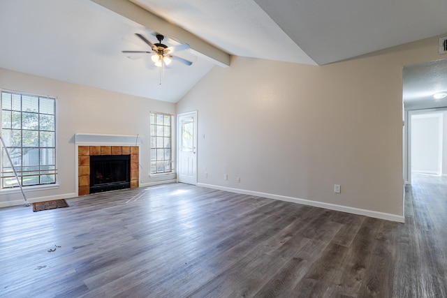 unfurnished living room featuring a fireplace, dark hardwood / wood-style floors, and a healthy amount of sunlight