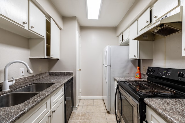 kitchen with light tile patterned flooring, sink, white cabinets, stainless steel appliances, and dark stone countertops