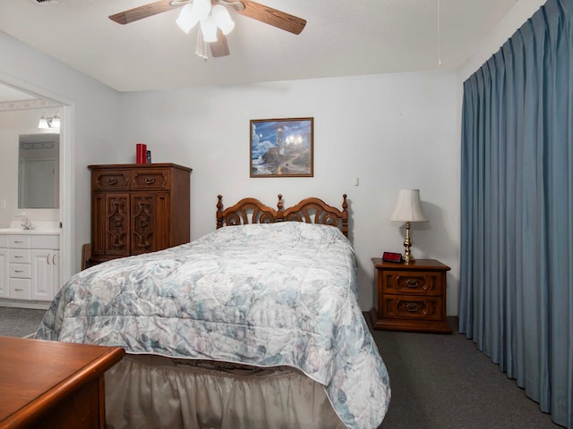 carpeted bedroom featuring ceiling fan and ensuite bathroom