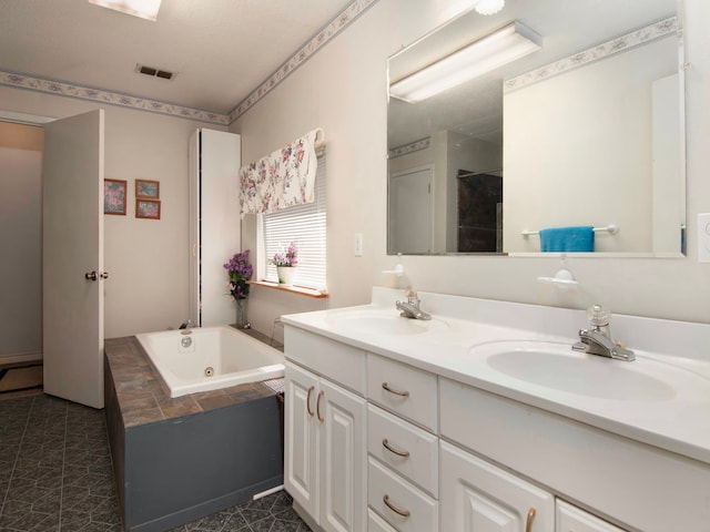 bathroom featuring a bathtub, a textured ceiling, and vanity