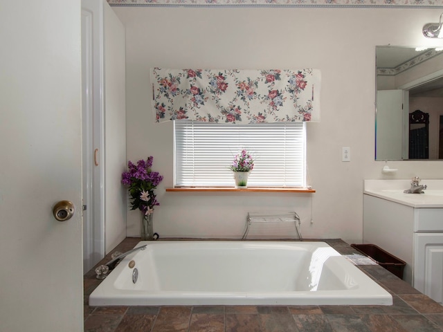 bathroom featuring a relaxing tiled tub and vanity