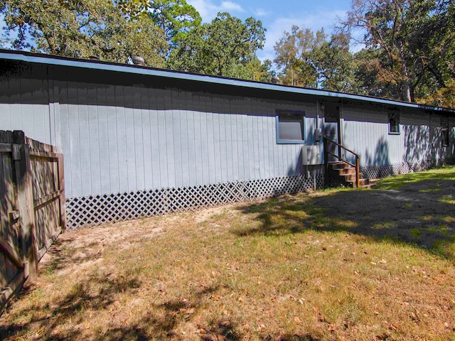 view of property exterior with a lawn