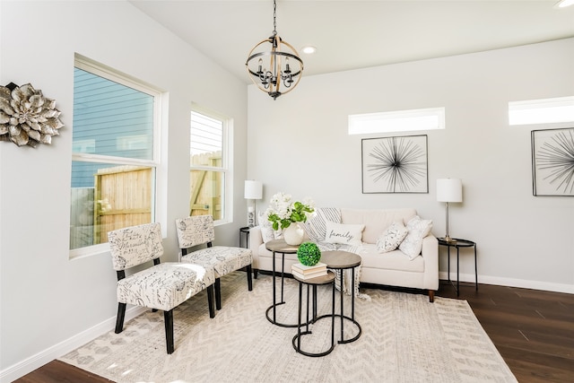 sitting room with a chandelier and dark hardwood / wood-style floors