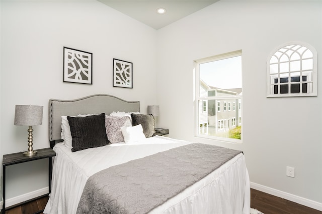 bedroom with dark hardwood / wood-style floors