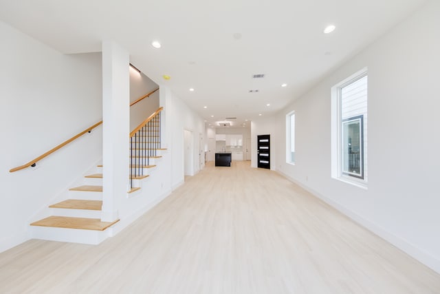 unfurnished living room featuring light wood-type flooring