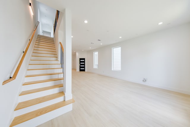 stairs with hardwood / wood-style floors