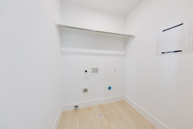 laundry room featuring hookup for a washing machine, hardwood / wood-style flooring, gas dryer hookup, and electric dryer hookup