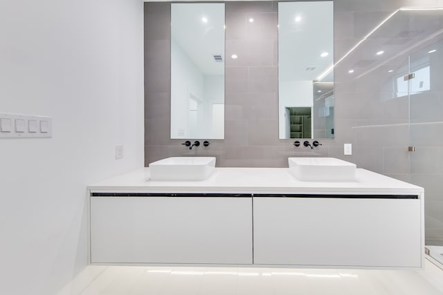 bathroom featuring vanity and tile walls