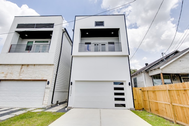 contemporary home featuring a balcony and a garage