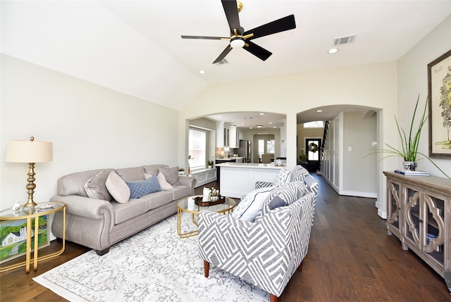 living room with lofted ceiling, dark hardwood / wood-style flooring, and ceiling fan