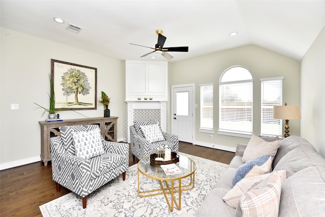 living room with lofted ceiling, ceiling fan, and dark wood-type flooring