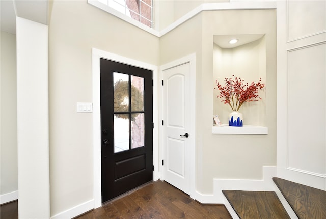 foyer with dark hardwood / wood-style floors