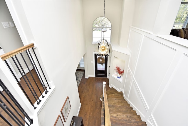 foyer featuring a notable chandelier, a high ceiling, and dark hardwood / wood-style floors