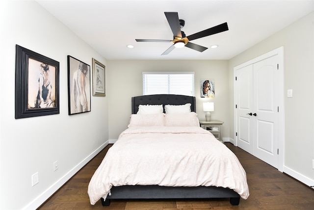 bedroom featuring dark hardwood / wood-style flooring, ceiling fan, and a closet