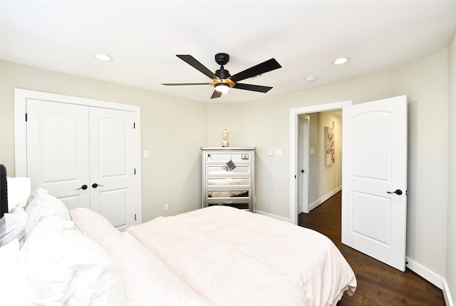 bedroom with ceiling fan, a closet, and dark wood-type flooring